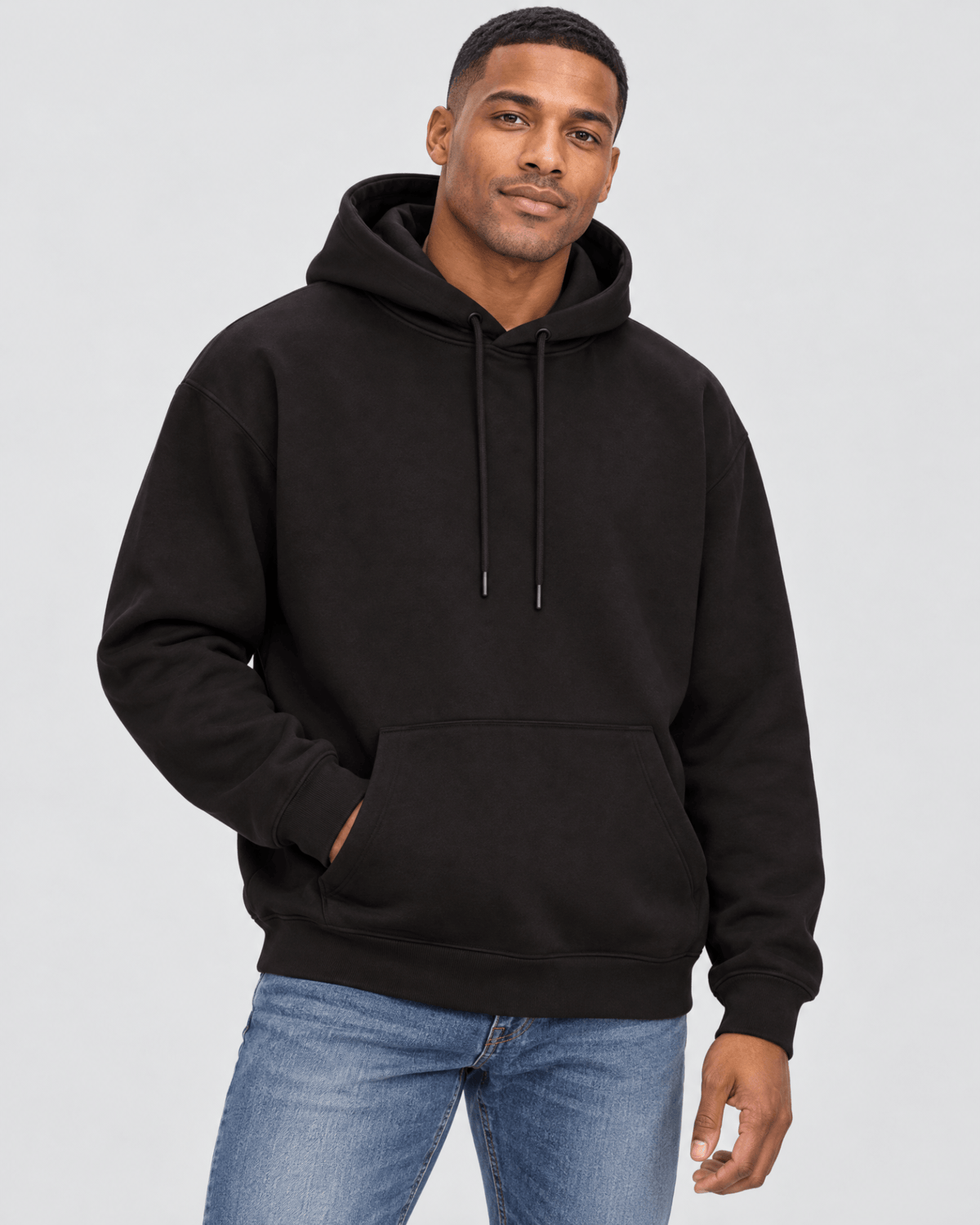 Men's Black Heavyweight Pullover Hoodie front 3/4 view with kangaroo pocket and premium fleece construction