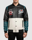 Black and white varsity jacket with racing-themed patches on a gray background