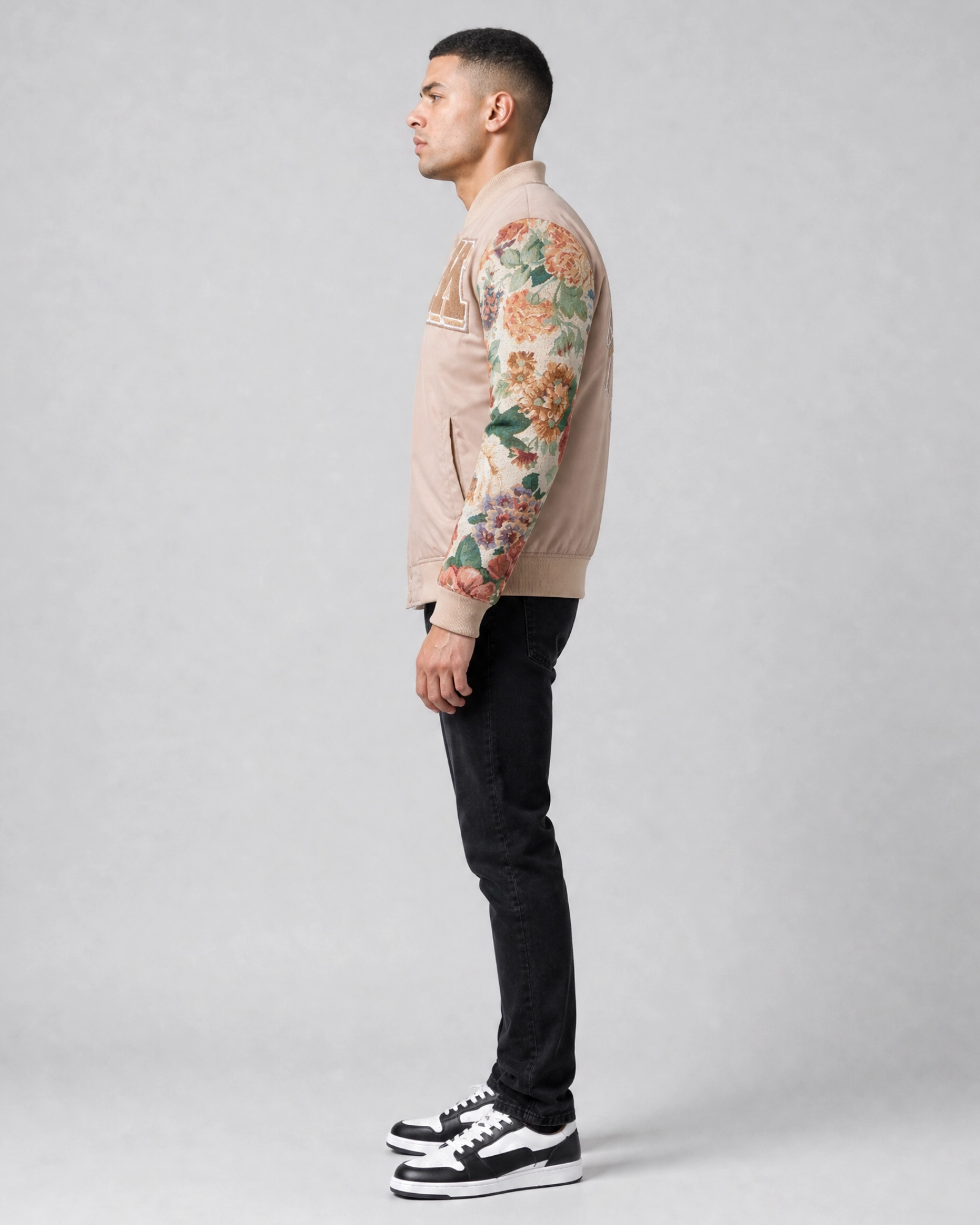 Ring of Fire Gibeon tapestry varsity jacket tan colorway on model side view
