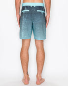 Person wearing blue and black striped shorts on a white background