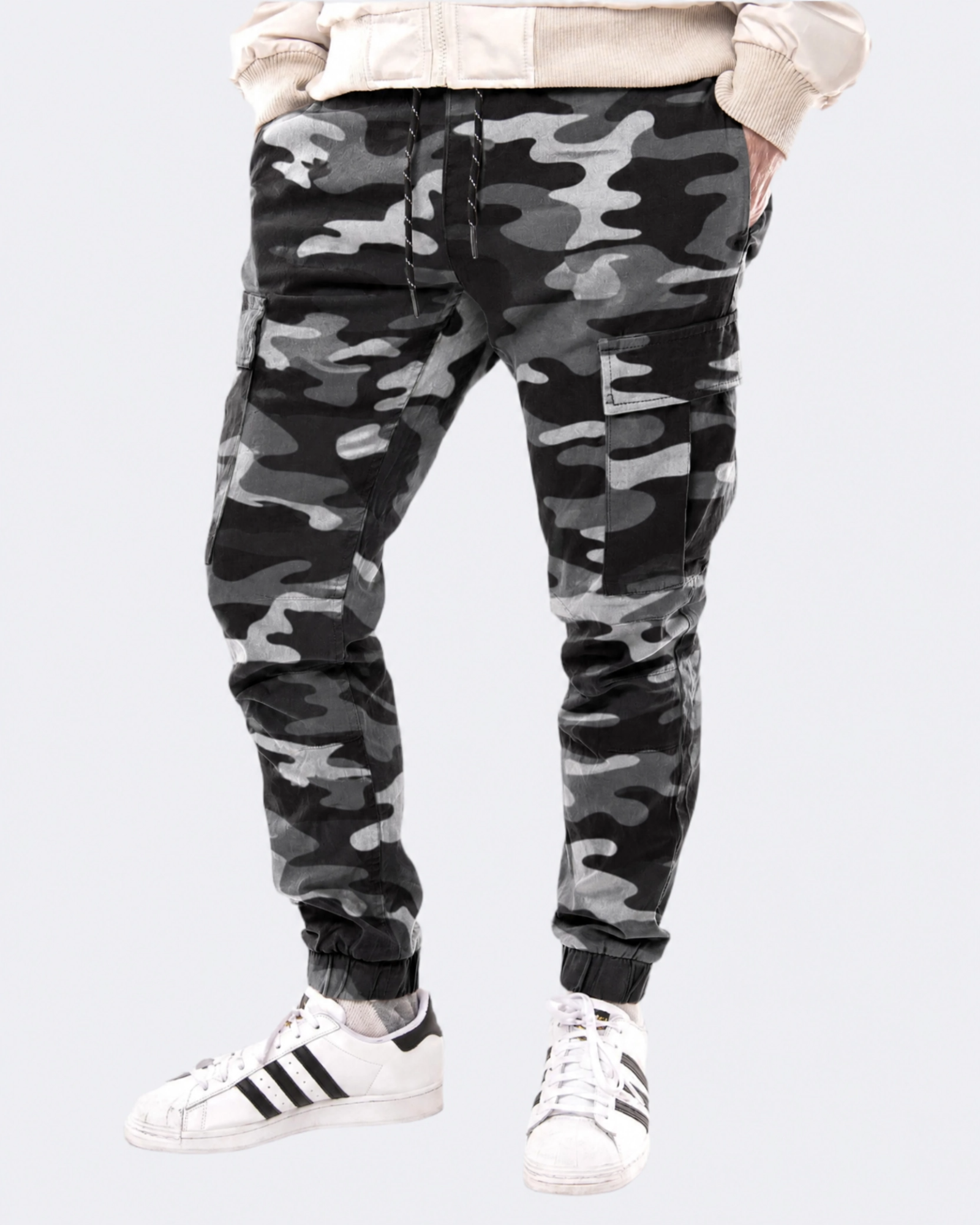 Infantry jogger pants in black camo shown on model from front view with cargo pockets and tapered fit
