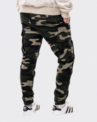 Infantry jogger pants in green camo shown on model from back view with cargo pockets and elastic cuffs