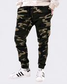 Infantry jogger pants in green camo shown on model from front view with cargo pockets and tapered fit