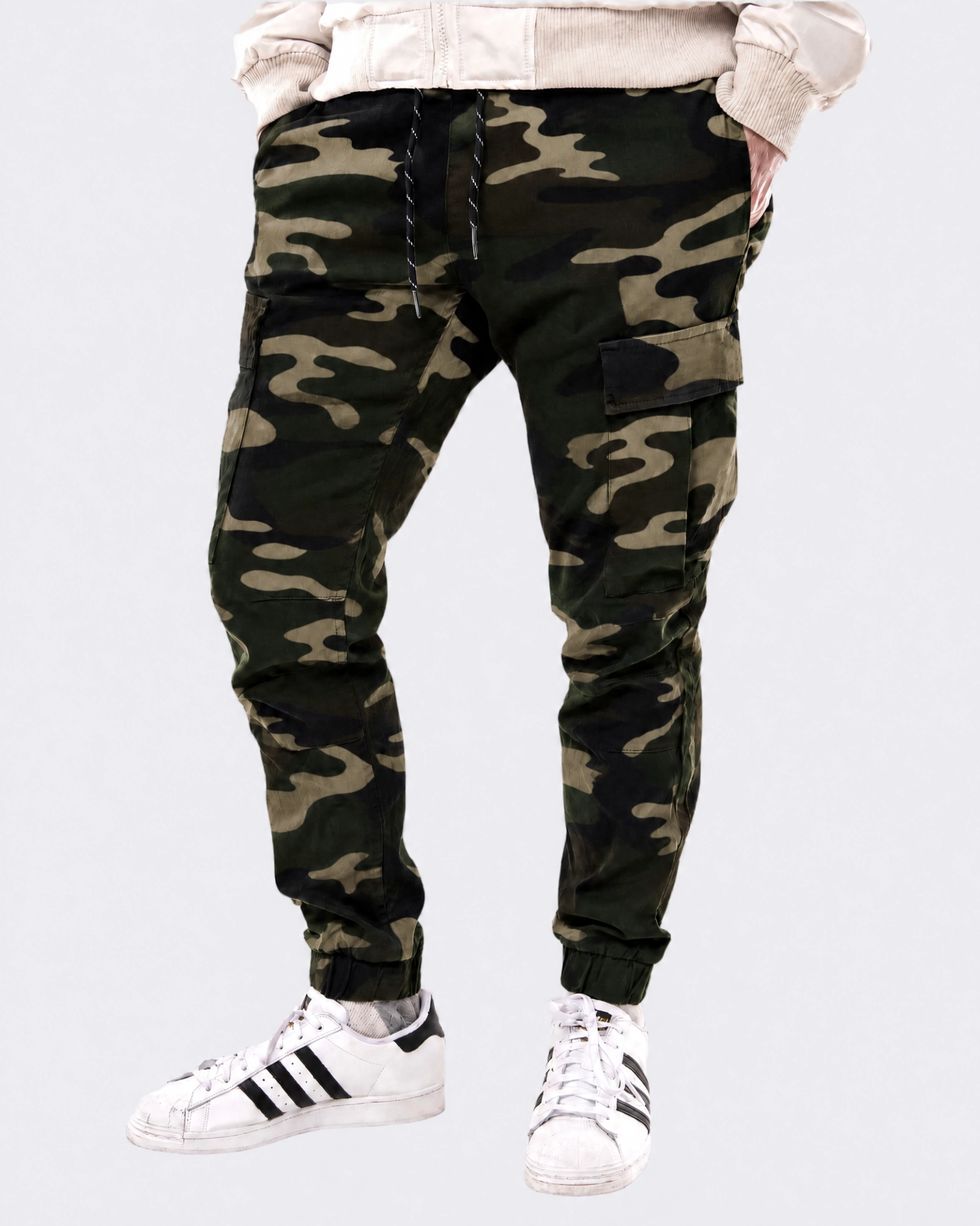 Infantry jogger pants in green camo shown on model from front view with cargo pockets and tapered fit