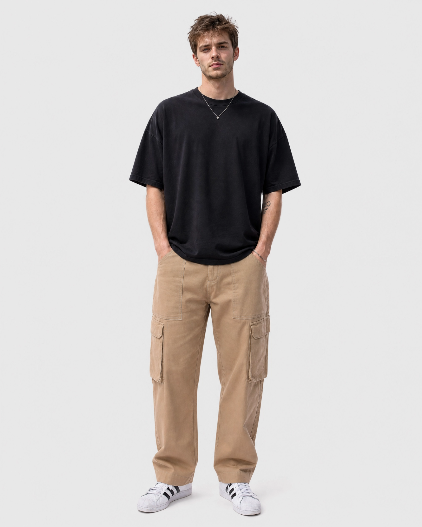 Model wearing Ledger khaki cargo pants with a relaxed fit tee front view