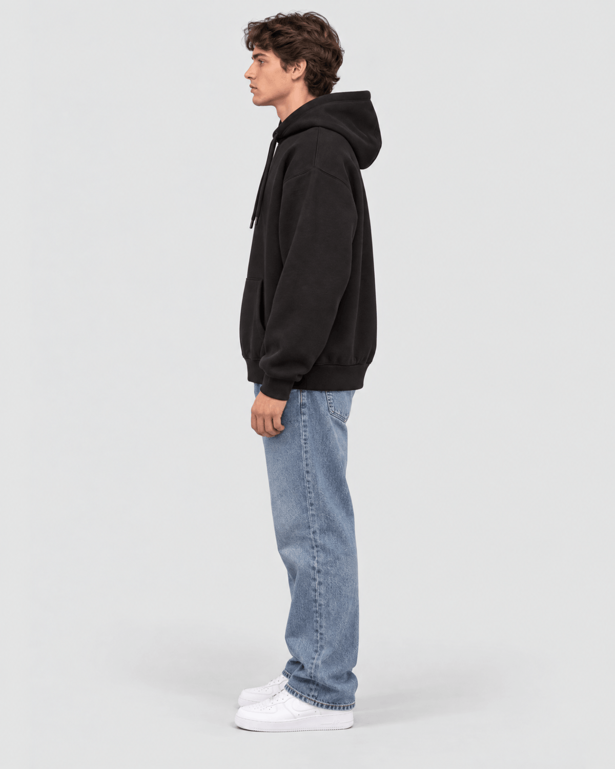 Men's Black Heavyweight Pullover Hoodie side profile view showing hood projection and body shape