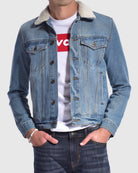 Mens denim trucker sherpa jacket in light blue with two chest pockets and button closure 