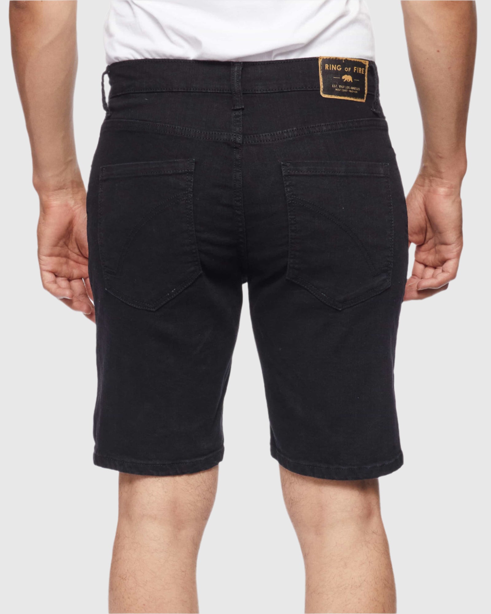 Back view of model in Black Paradise Men’s Ripper Denim Shorts by Ring of Fire