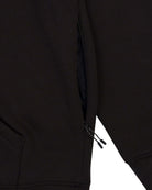 Black Heavyweight Pullover Hoodie rib waistband and side seam detail closeup